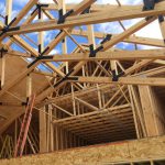 Timber trusses in under construction building frame.