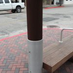 Close up, side view of installed Gun Barrel Piling at Galveston bus stop.