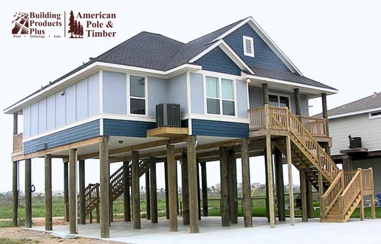Gun Barrel Pilings design on a raised beach home with uniform round foundation pilings visible beneath the structure